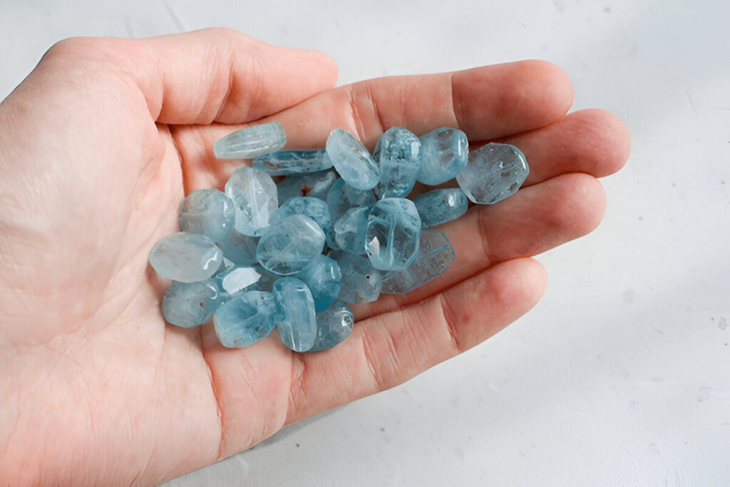 Aquamarine stone lies in the hand