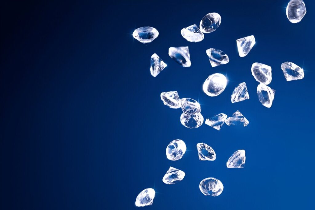 a lot of shiny white topaz gems falling on a blue surface