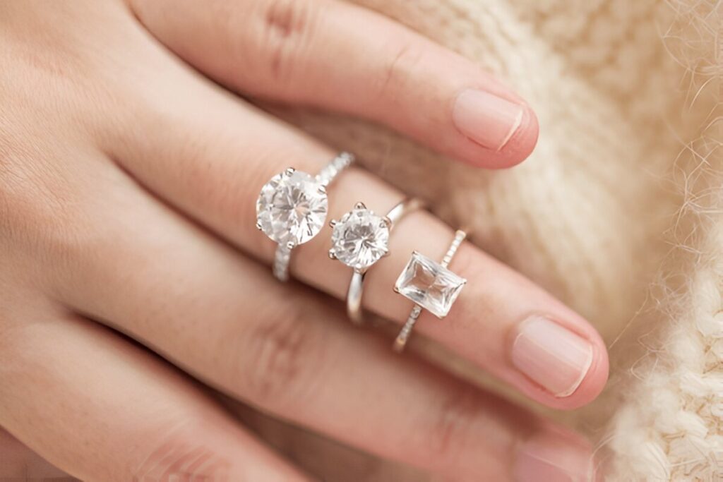 Female hand with beautiful jewelry white topaz rings